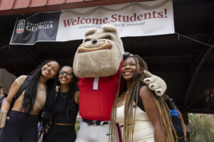 University of Georgia mascot Hairy Dawg poses for photos with students during the first day of Fall semester at Tate Plaza.